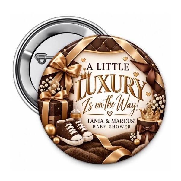 Brown and gold luxury baby shower button with gold ribbons, baby shoes, crown, and custom baby shower wording.