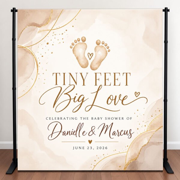 Personalized neutral baby shower backdrop with watercolor baby footprints, champagne gold accents, and Tiny Feet Big Love lettering