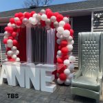 custom Name Table balloon arch and throw chair the brat shack