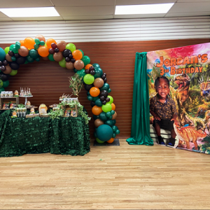 Dinosaur Backdrop and balloon arch made by the brat shack