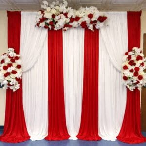 red and white floral draped fabric backdrop