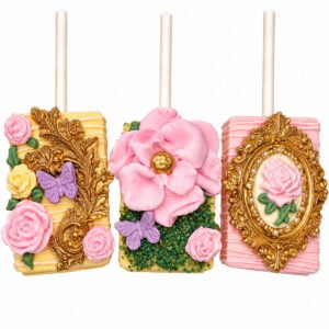 Enchanted floral chocolate covered Rice Krispies Treats decorated with pink roses, butterflies, green accents and ornate gold frames.
