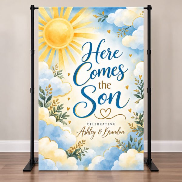 Here Comes the Son baby shower backdrop with watercolor golden sun, blue clouds, and personalized parents' names on a vinyl backdrop stand.