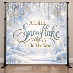 A Little Snowflake Is On The Way baby shower backdrop in icy blue, white and gold with hanging snowflakes